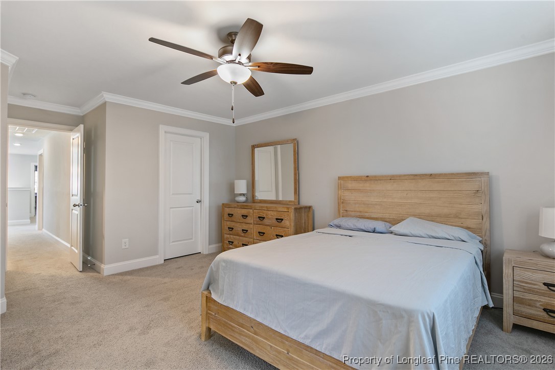 88 Spruce Hollow Circle Spring Lake, NC 28390 - Photo 28 of 48 a bedroom with a bed and a ceiling fan