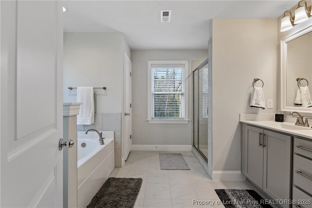 88 Spruce Hollow Circle Spring Lake, NC 28390 - Photo 29 of 48 a bathroom with a sink and a shower