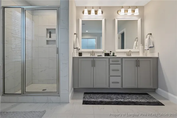 a bathroom with a shower sink and mirror
