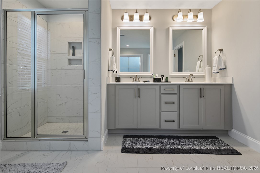 88 Spruce Hollow Circle Spring Lake, NC 28390 - Photo 30 of 48 a bathroom with mirror shower and vanity