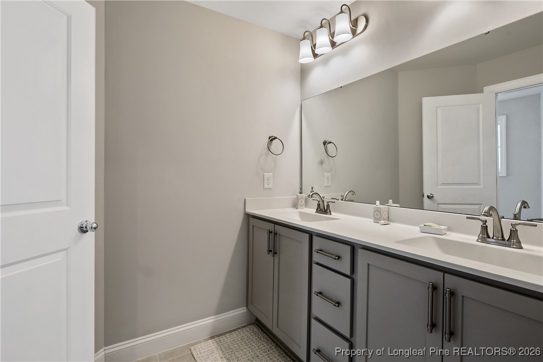88 Spruce Hollow Circle Spring Lake, NC 28390 - Photo 43 of 48 a bathroom with a double vanity sink and a mirror