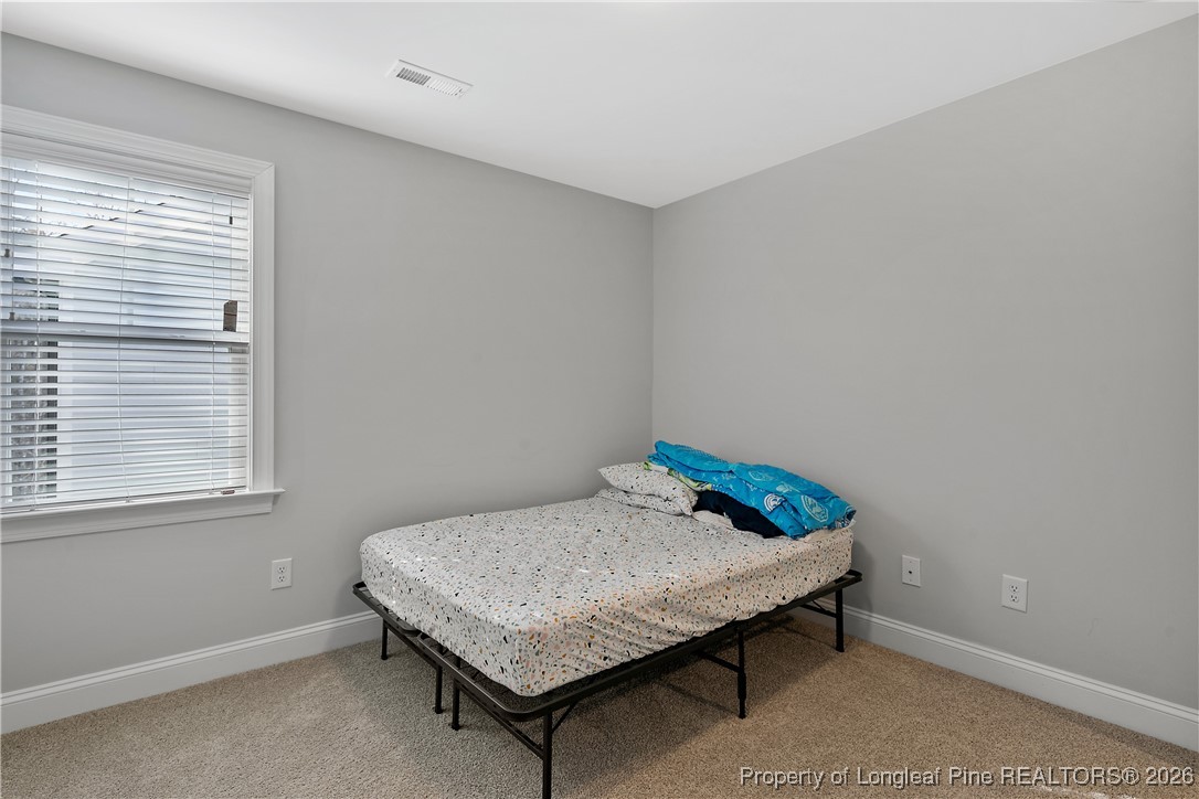 88 Spruce Hollow Circle Spring Lake, NC 28390 - Photo 45 of 48 a room with a table and a window