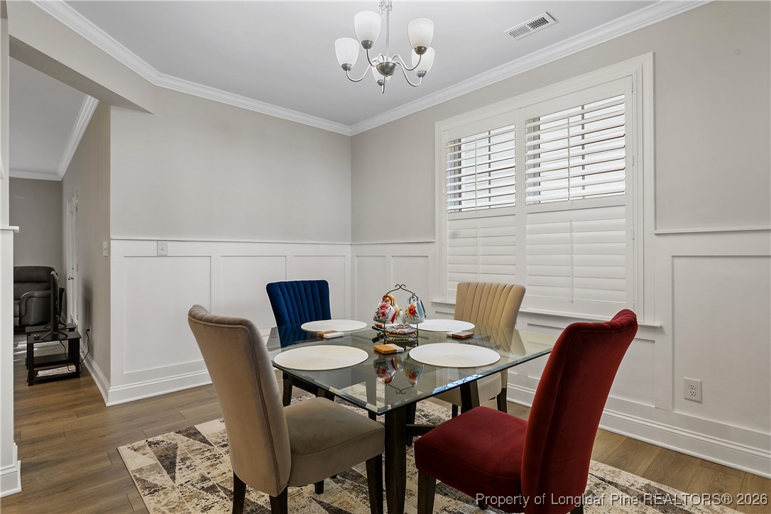 88 Spruce Hollow Circle Spring Lake, NC 28390 - Photo 9 of 48 a view of a dining room with furniture window and wooden floor