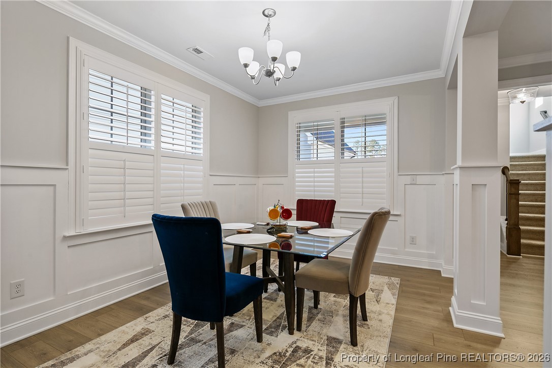 88 Spruce Hollow Circle Spring Lake, NC 28390 - Photo 10 of 48 a view of a dining room with furniture window and wooden floor