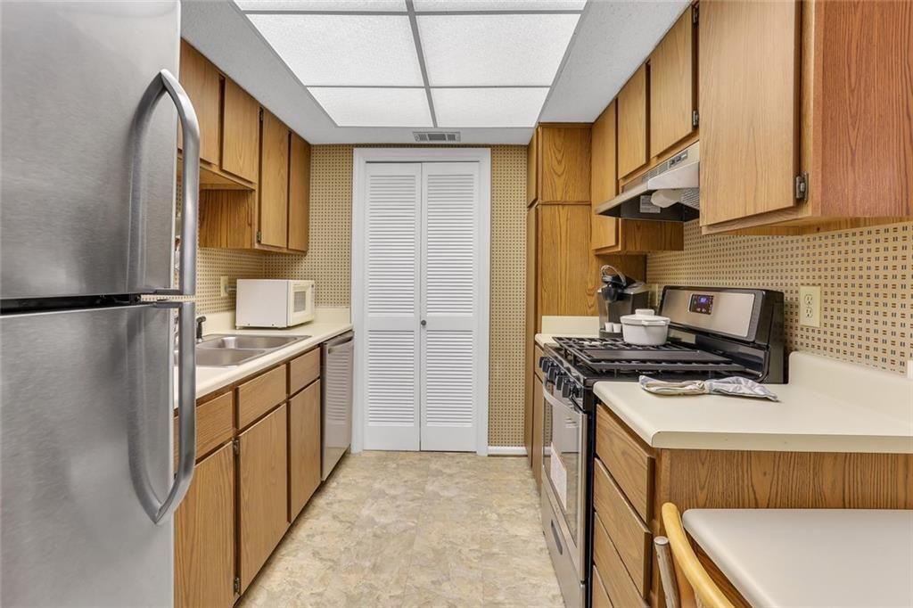 3445 Ivys Walk Atlanta, GA 30340 - Photo 5 of 21 a kitchen with stainless steel appliances granite countertop a sink stove and refrigerator