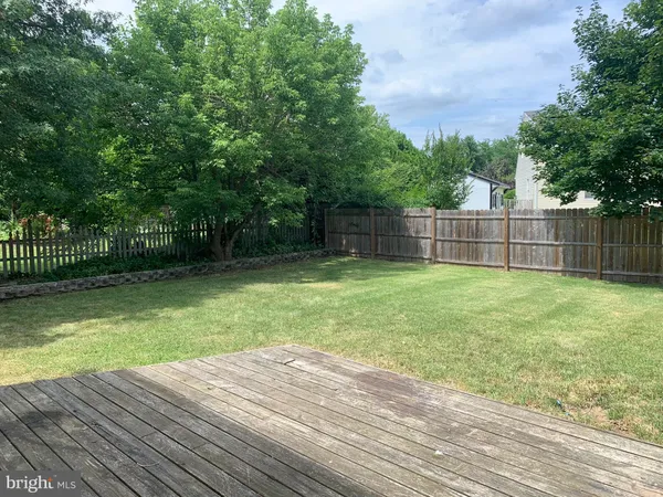 a view of a backyard with a wooden fence