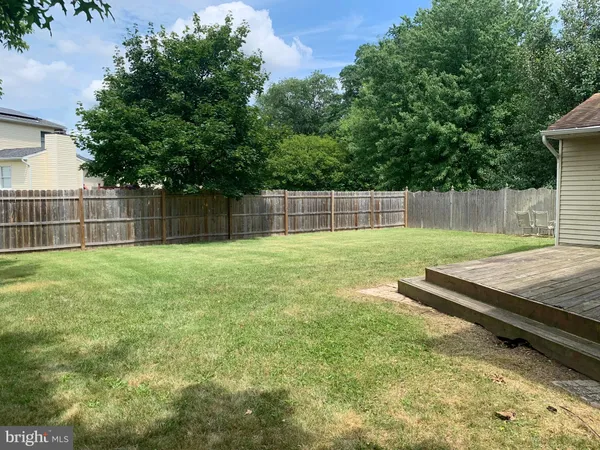 a view of a backyard with a wooden fence