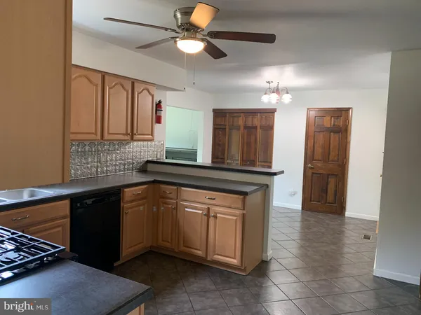 a kitchen with stainless steel appliances granite countertop a sink and a refrigerator