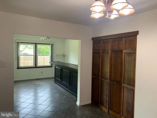a kitchen with a refrigerator and chandelier