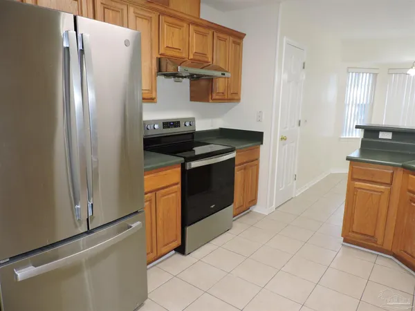 an empty room with a ceiling fan and window
