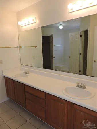 a bathroom with a double vanity sink and a mirror