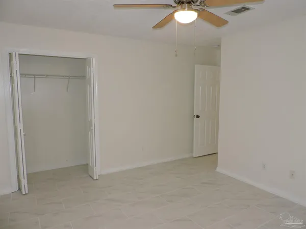 a view of backyard with wooden fence and large trees