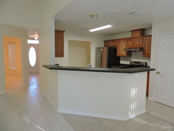 a kitchen with stainless steel appliances granite countertop a refrigerator and a sink