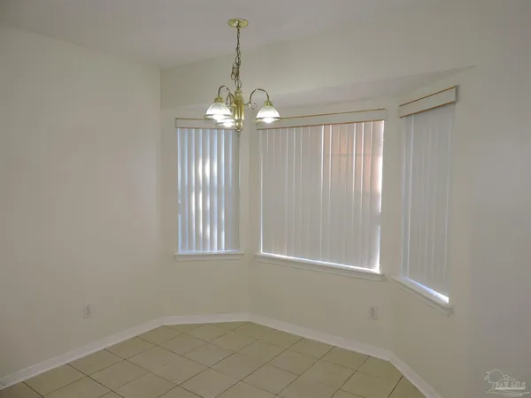 a kitchen with granite countertop a sink and a white cabinets