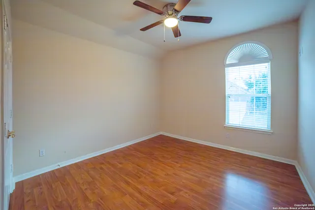 wooden floor in an empty room with a window