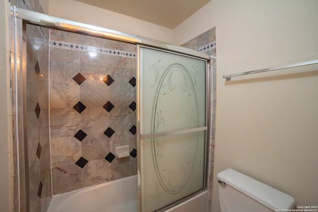 a bathroom with a shower and a toilet