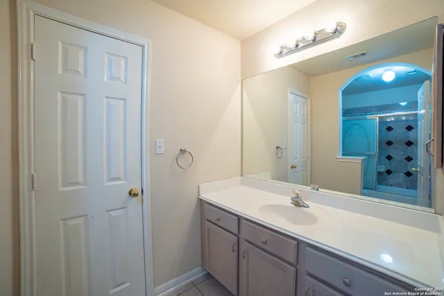 a bathroom with a sink double vanity and a mirror