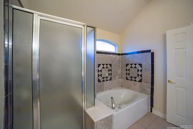a bathroom with a bathtub and shower