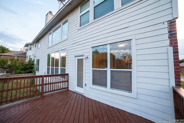 a view of a house with wooden deck