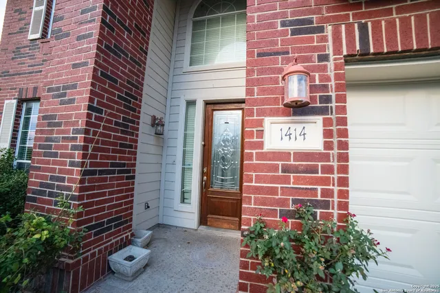 a front view of a building with a garden