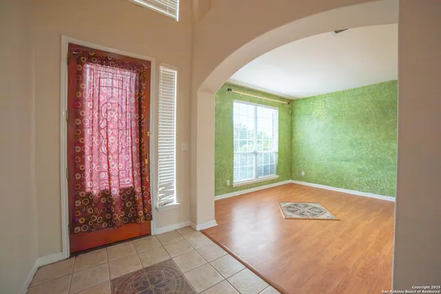 a view of an empty room with glass door