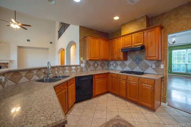 a kitchen with stainless steel appliances granite countertop a sink and cabinets