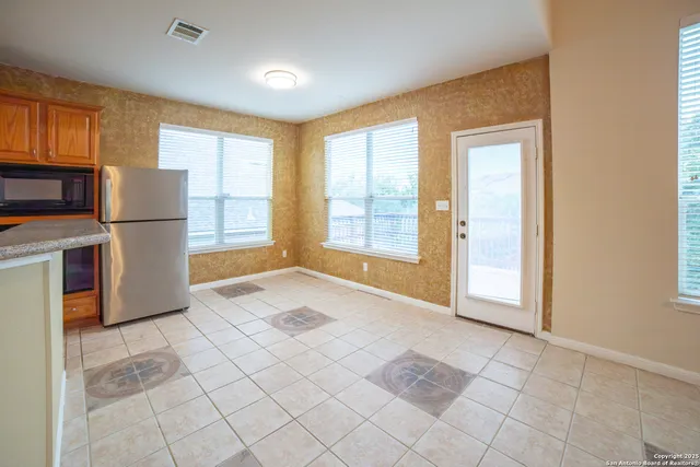 a view of a kitchen with furniture and a window