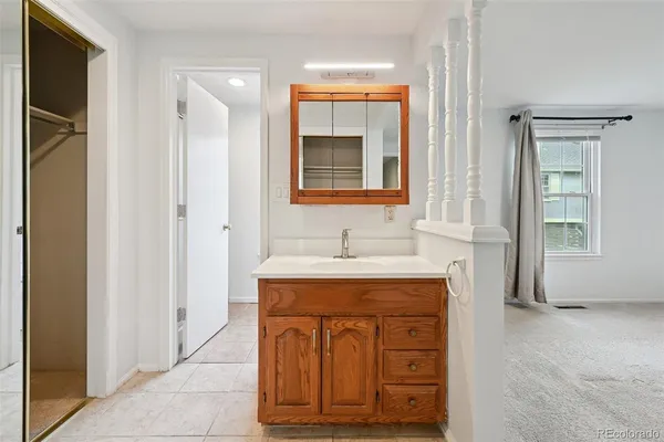 a bathroom with a sink vanity and mirror
