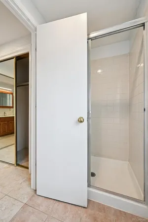 a bathroom with a glass shower door