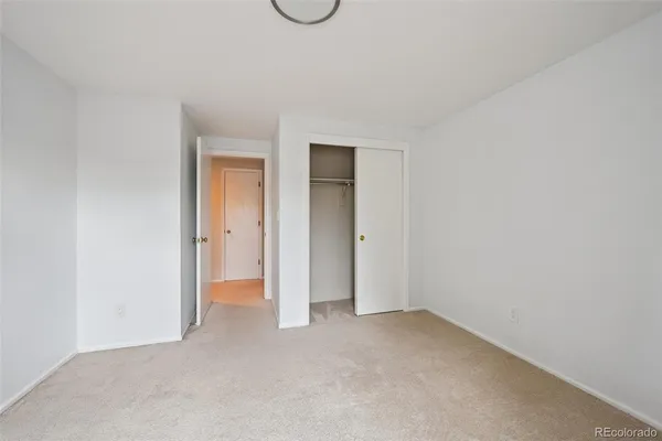 a view of an empty room and closet area