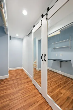 a view of a room with wooden floor