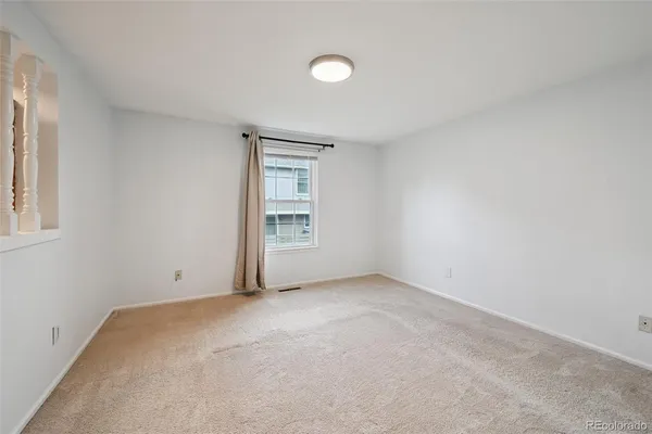 an empty room with windows and closet