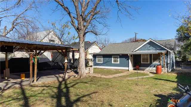 a front view of a house with a yard table and chairs