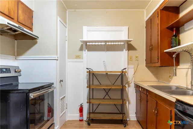 a view of a storage & utility room with a sink