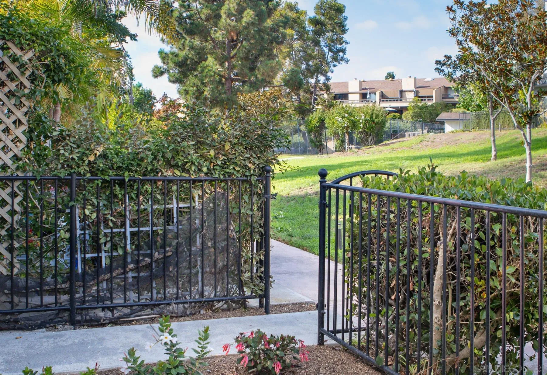 7325 Alicante Road, Unit A Carlsbad, CA 92009 - Photo 4 of 44 a view of a pathway with a wrought fence
