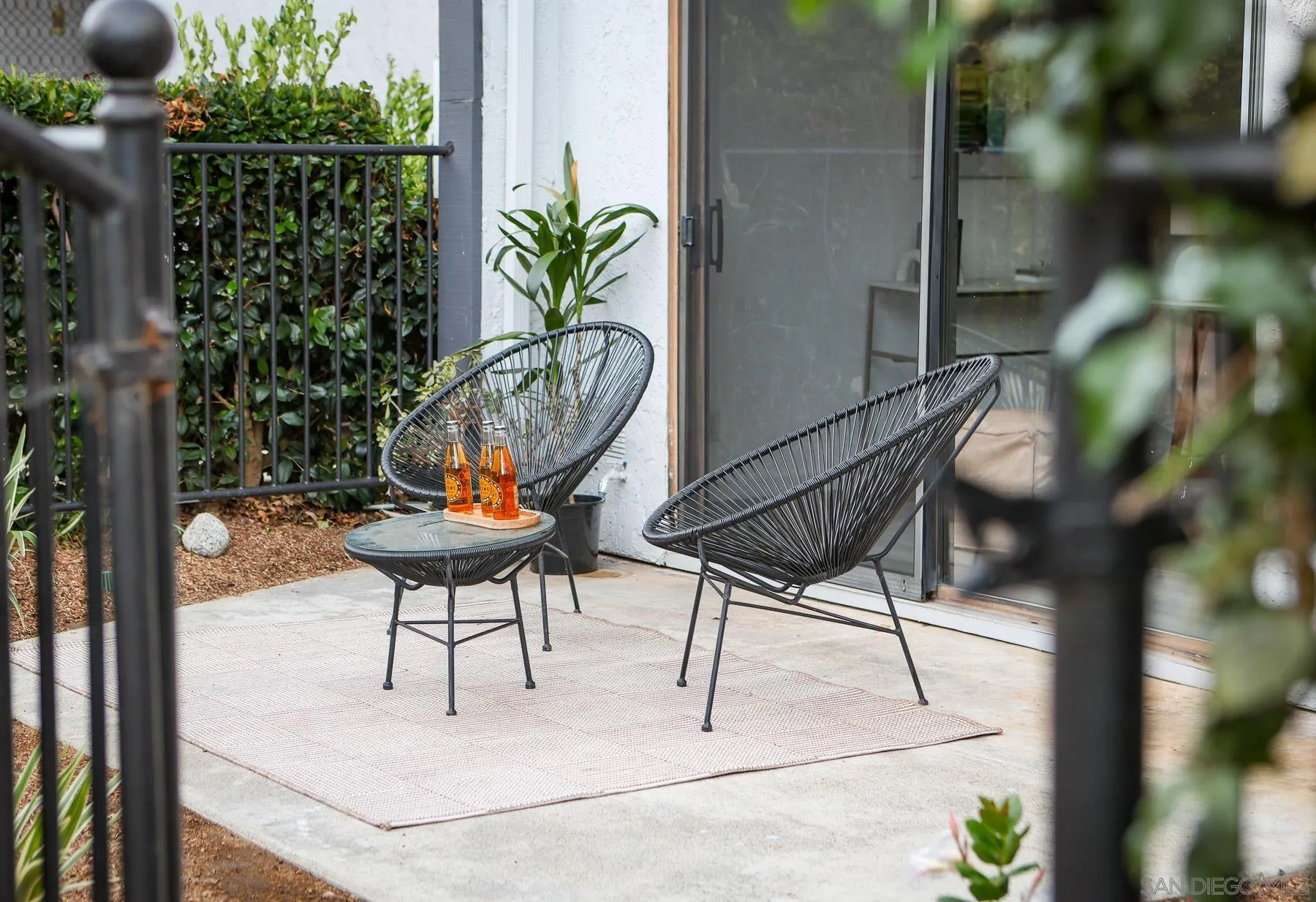 7325 Alicante Road, Unit A Carlsbad, CA 92009 - Photo 5 of 44 a backyard of a house with table and chairs