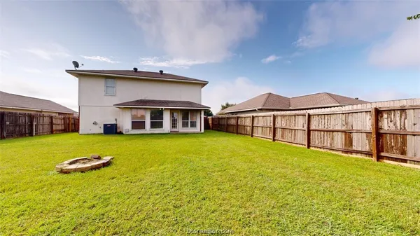 a view of a house with pool and a yard