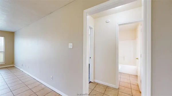a view of a bathroom with a glass door and a window