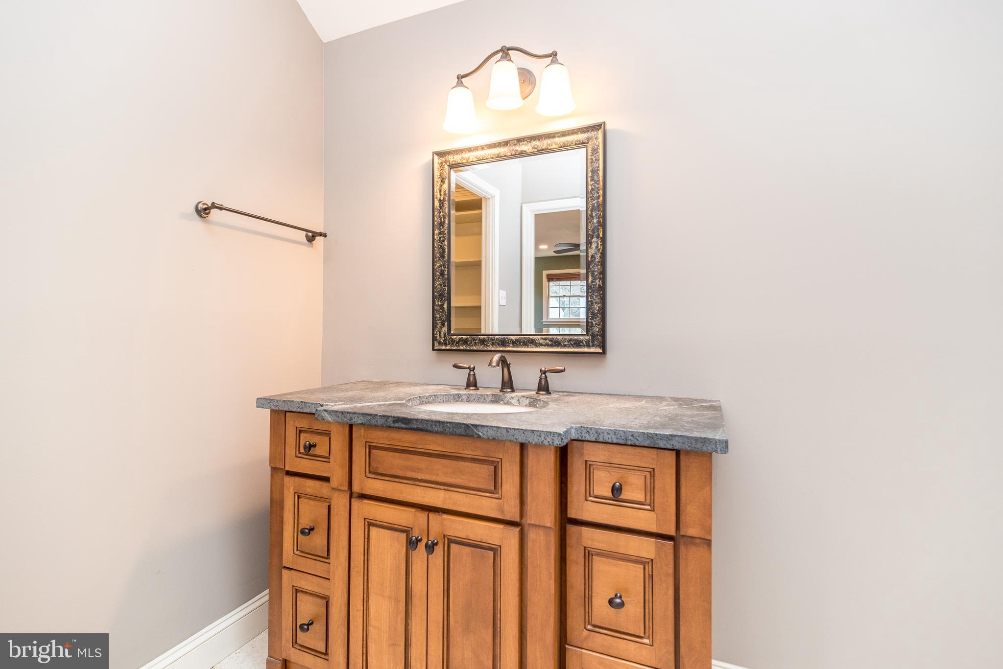 46 John Dyer Way Doylestown, PA 18902 - Photo 45 of 76 a bathroom with a granite countertop sink and a mirror