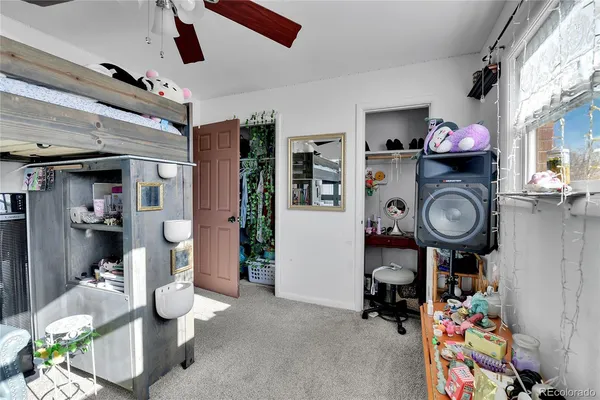 a living room with lots of furniture and baby bed
