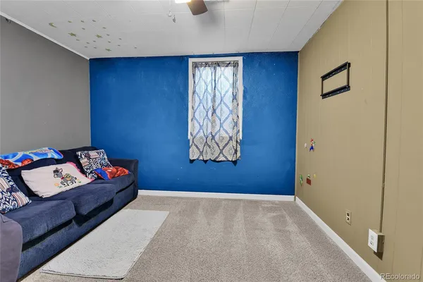 a living room with blue walls and furniture