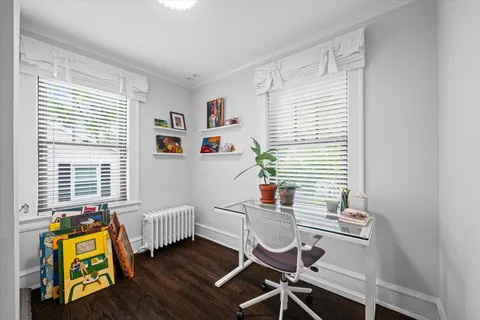a dining room with furniture and a window