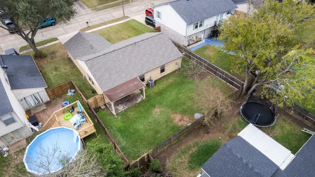 aerial view of a house with a yard