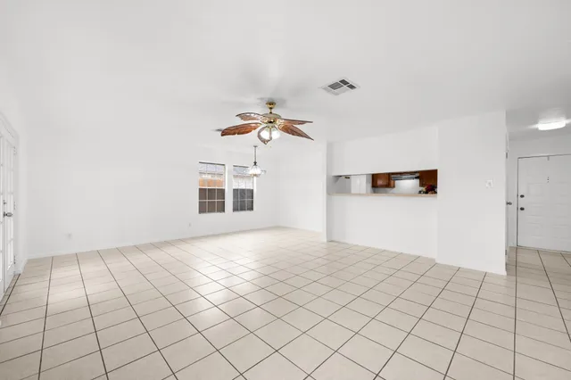 a view of a livingroom with an empty space and a stove top oven