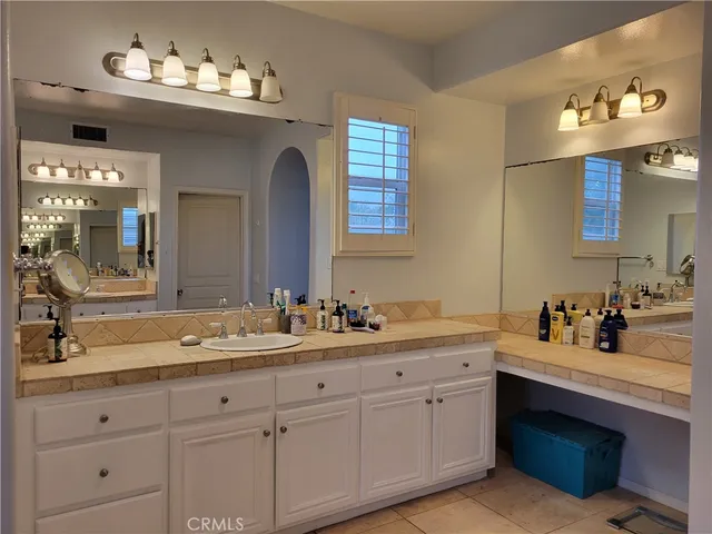 a bathroom with a sink vanity and mirror