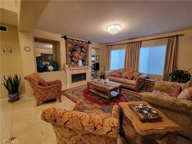a living room with furniture a couch and a window