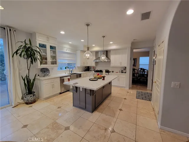 a kitchen with white cabinets and appliances