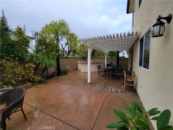 a view of a backyard with sitting area and entertaining space