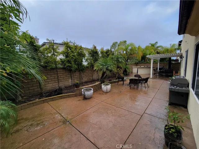 a view of a patio with couches and table and potted plants