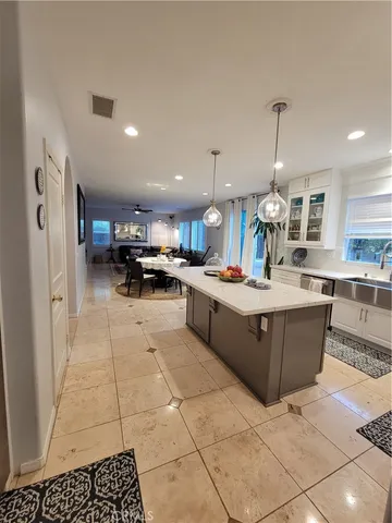 a kitchen that has a lot of cabinets in it and wooden floors